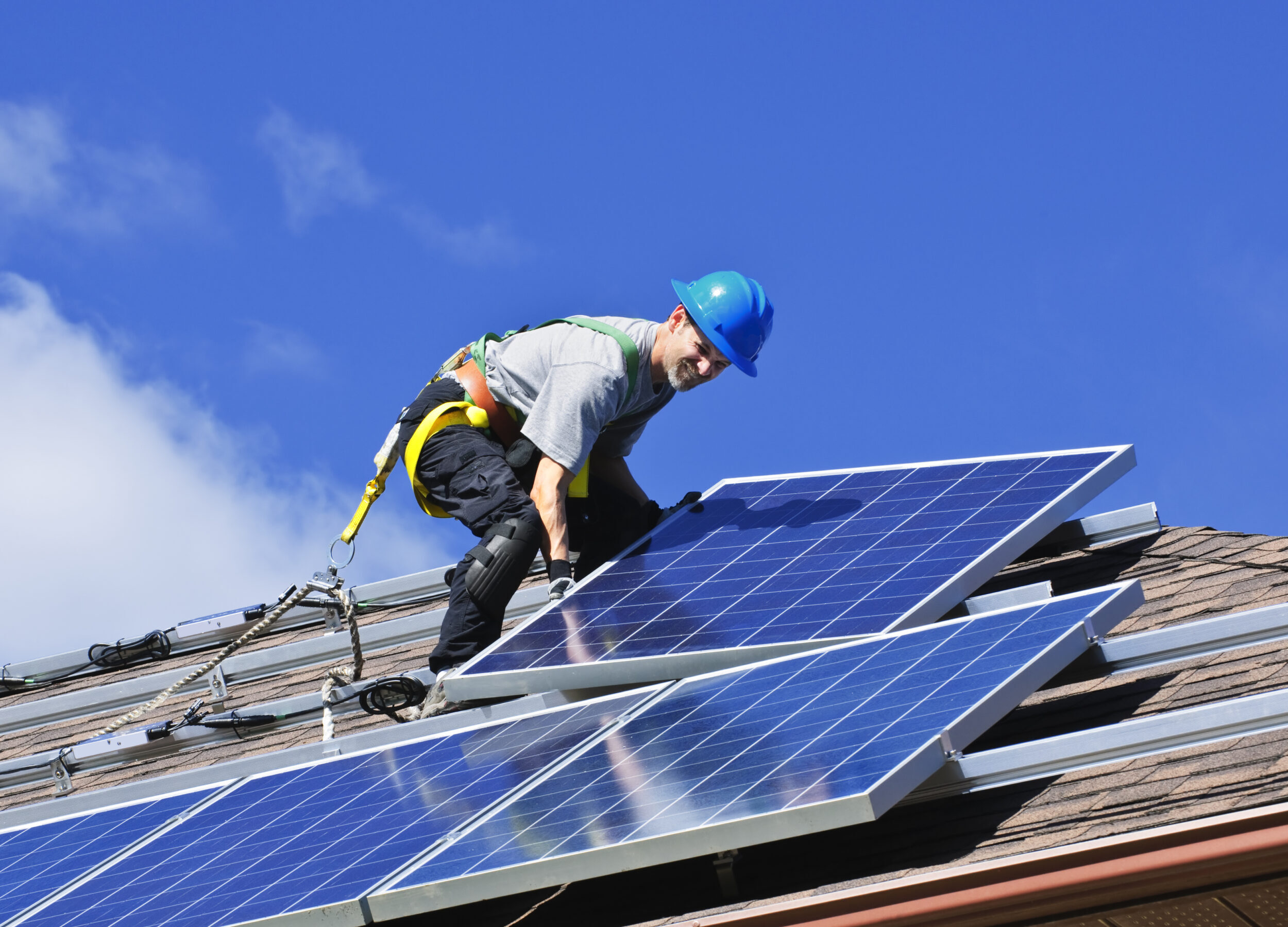 Under The Son Solar installing alternative energy photovoltaic solar panels on roof in Surprise Arizona
